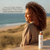 Smiling woman with defined curls using Haetsia La Primavera Argan Oil Shampoo – hydration and frizz control