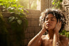 Woman washing curly hair with rich foam under shower – Haetsia clean haircare ritual inspired by nature