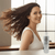 Woman with healthy flowing hair using Haetsia La Renaissance Revitalizing Shampoo – Royal Jelly, Biotin, and Bergamot